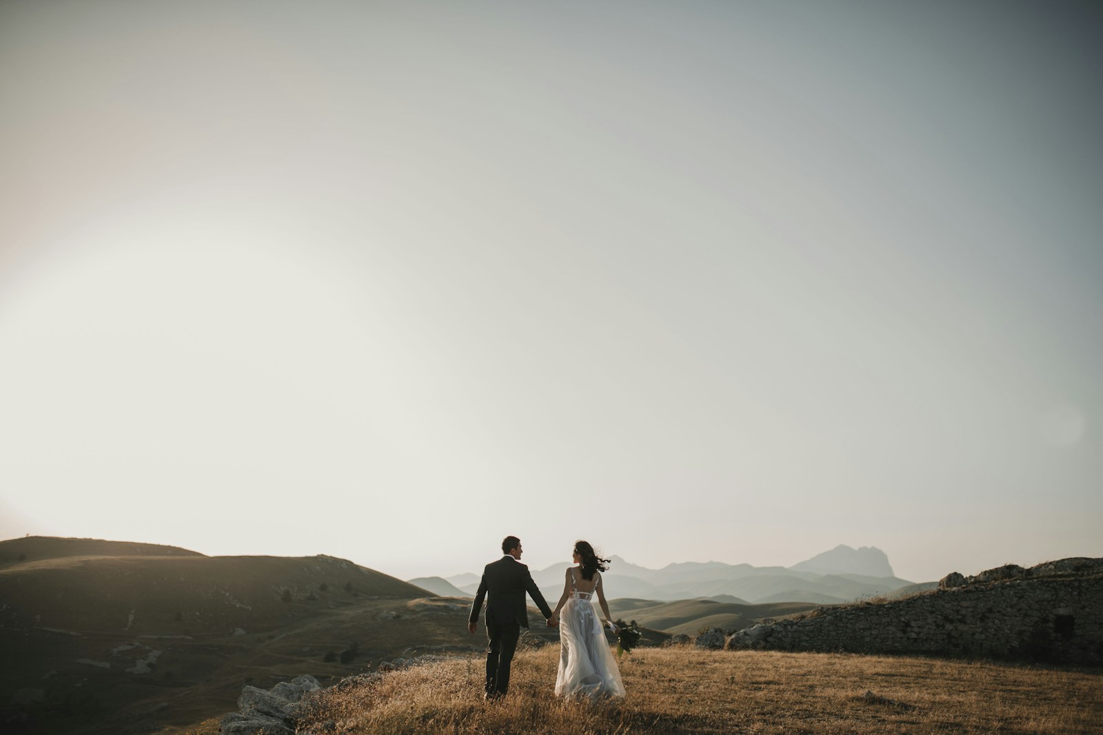 Couple on a hillside at golden hour